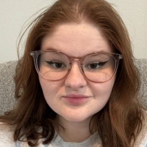 Brown haired woman with glasses