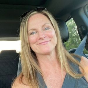 Blonde woman in car with sunglasses